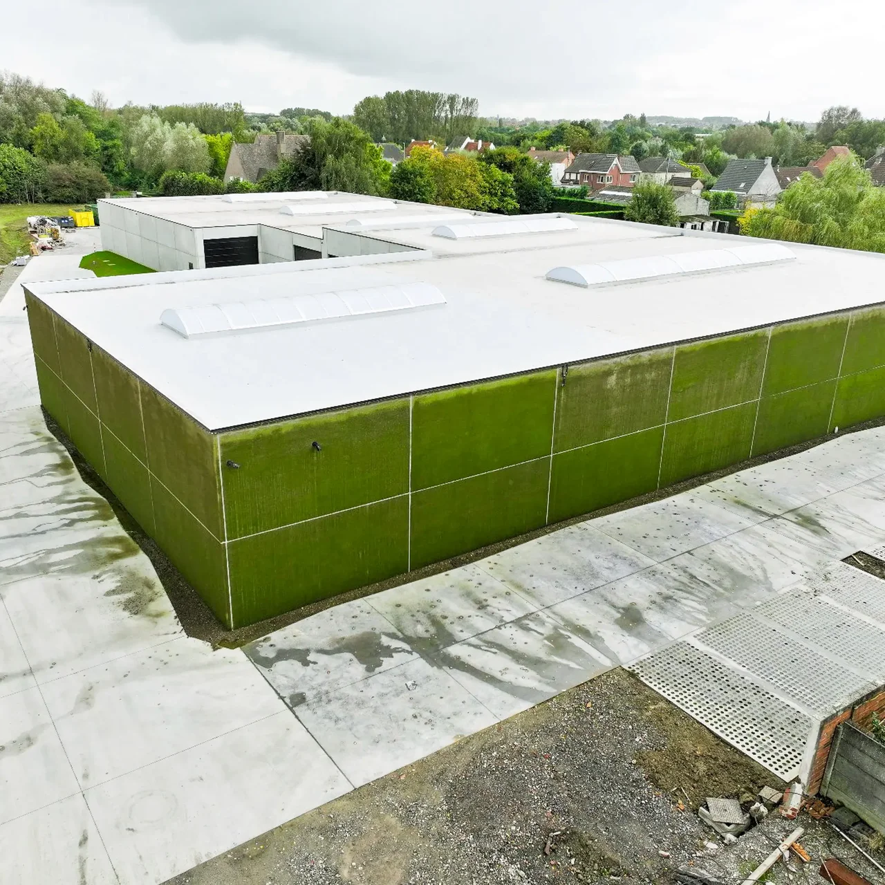 Industrial warehouse in Kortrijk with a green facade, seen from above