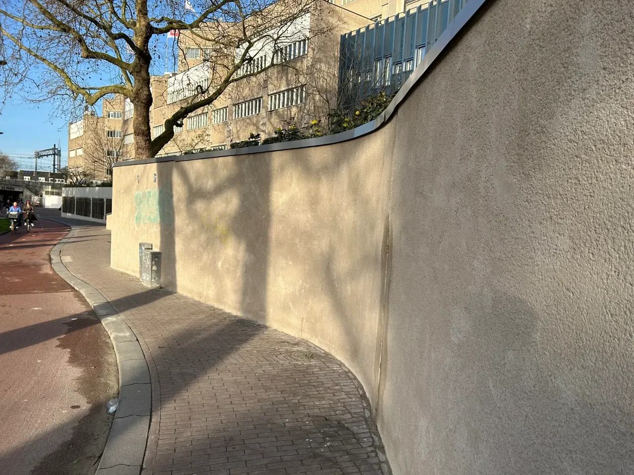 Retaining wall next to a street in Utrecht, with a tree in front